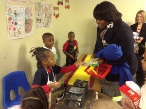 Children engaged in play in the grocery store they created. 